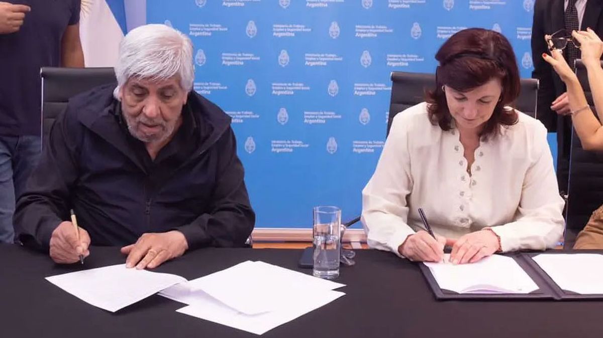 El secretario general de Camioneros, Hugo Moyano, y la ministra de Trabajo, Raquel Olmos, rubrican el acuerdo en paritarias.