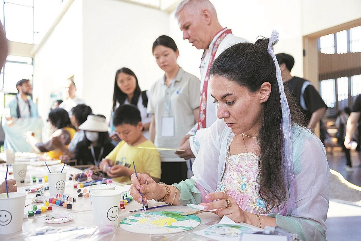 Una mujer vestida con un hanfu pinta un abanico chino en Huzhou, provincia de Zhejiang. XINHUA Una mujer vestida con un hanfu pinta un abanico chino en Huzhou, provincia de Zhejiang. XINHUA