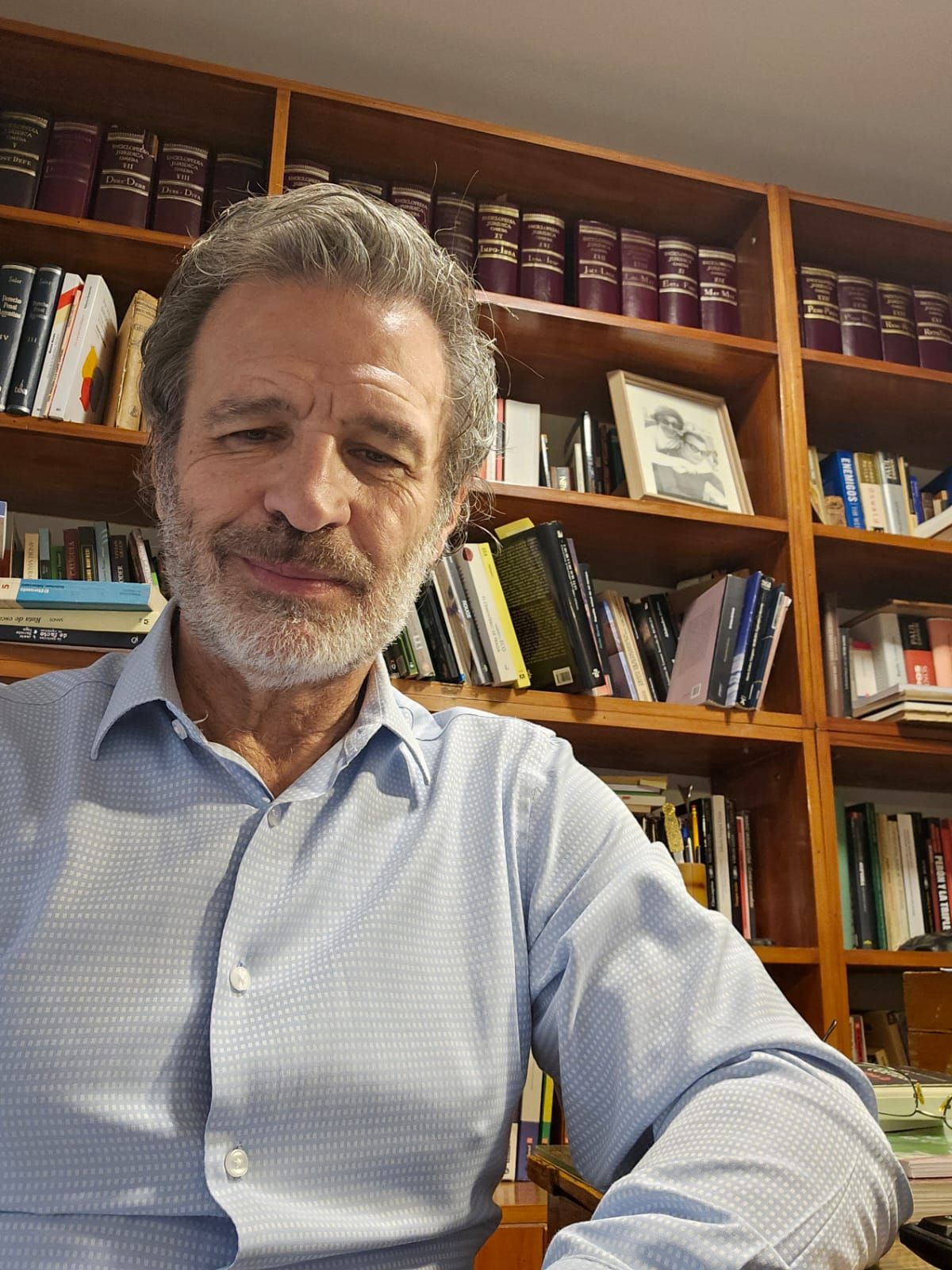 El fiscal en su biblioteca, donde se destaca una foto de sus padres. El fiscal en su biblioteca, donde se destaca una foto de sus padres.
