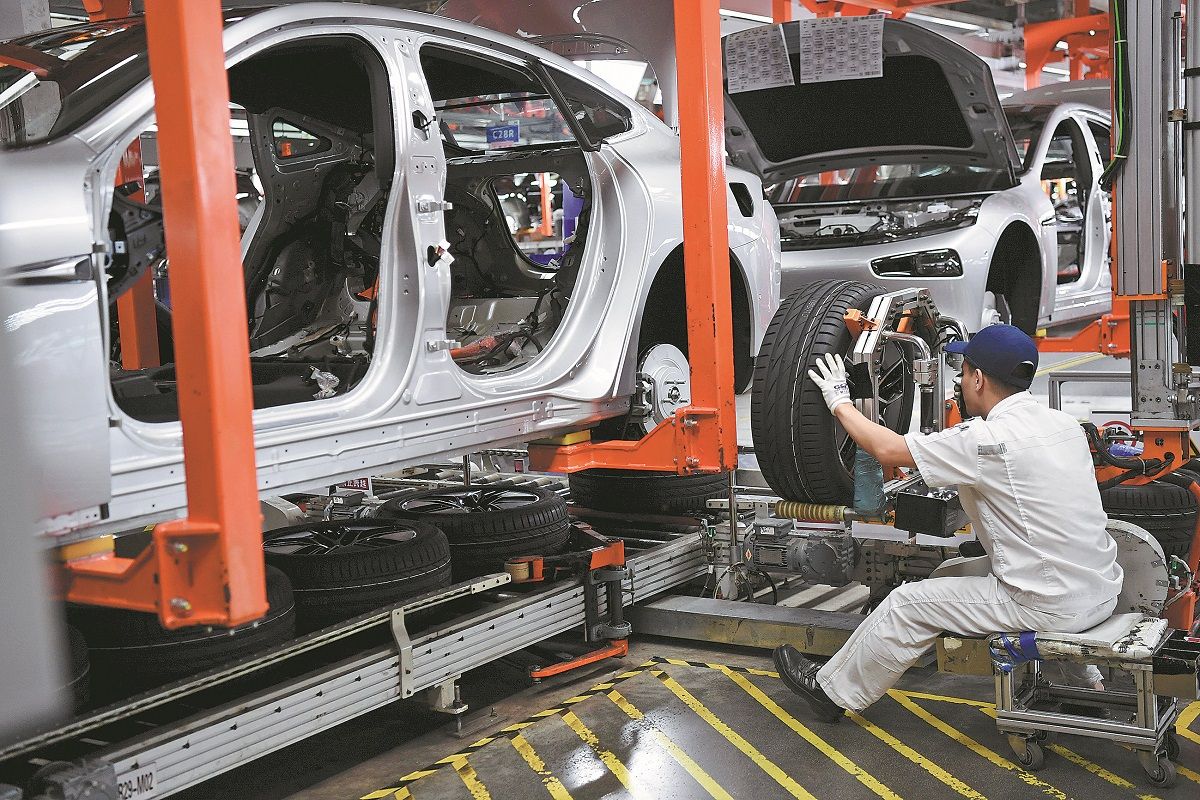 Un empleado trabaja en la línea de montaje de un fabricante de vehículos de nueva energía en Zhaoqing, provincia de Guangdong. DENG HUA / XINHUA