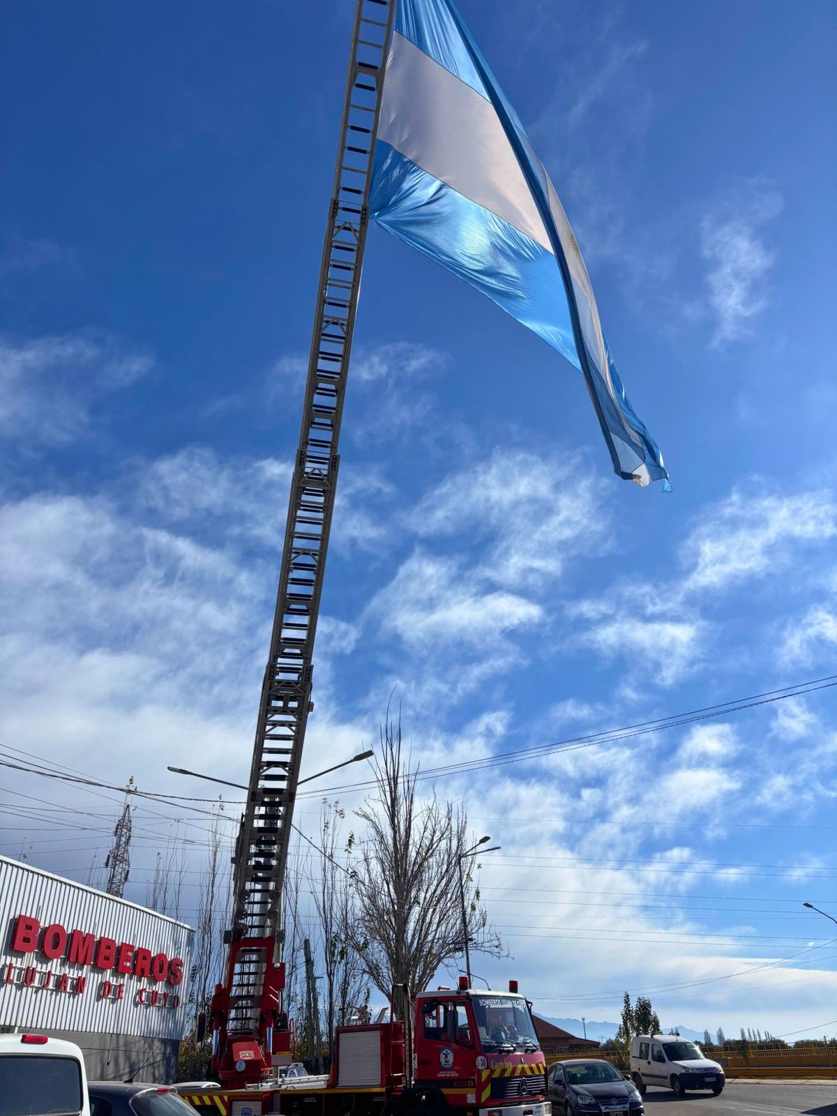La imagen de la bandera argentina aferrada a la escalera mecánica de la autobomba. La imagen de la bandera argentina aferrada a la escalera mecánica de la autobomba.