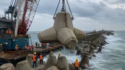lazan 2.000 bloques de hormigon al oceano para la construccion de un barrera que frena el avance del mar