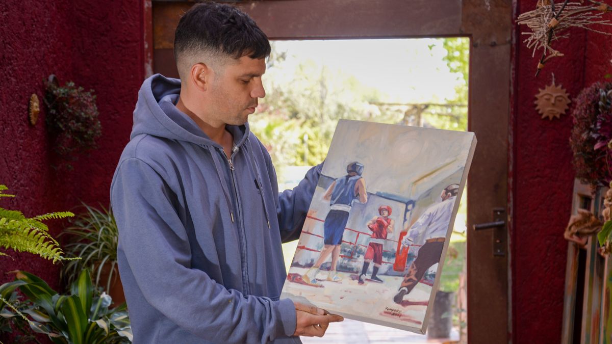 Orgulloso de su obra. Leandro muestra su pintura basada en una acción pugilística real, con él como protagonista.