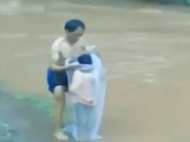 Video: un padre mete en una bolsa a sus hijos para que crucen el río y puedan ir a la escuela