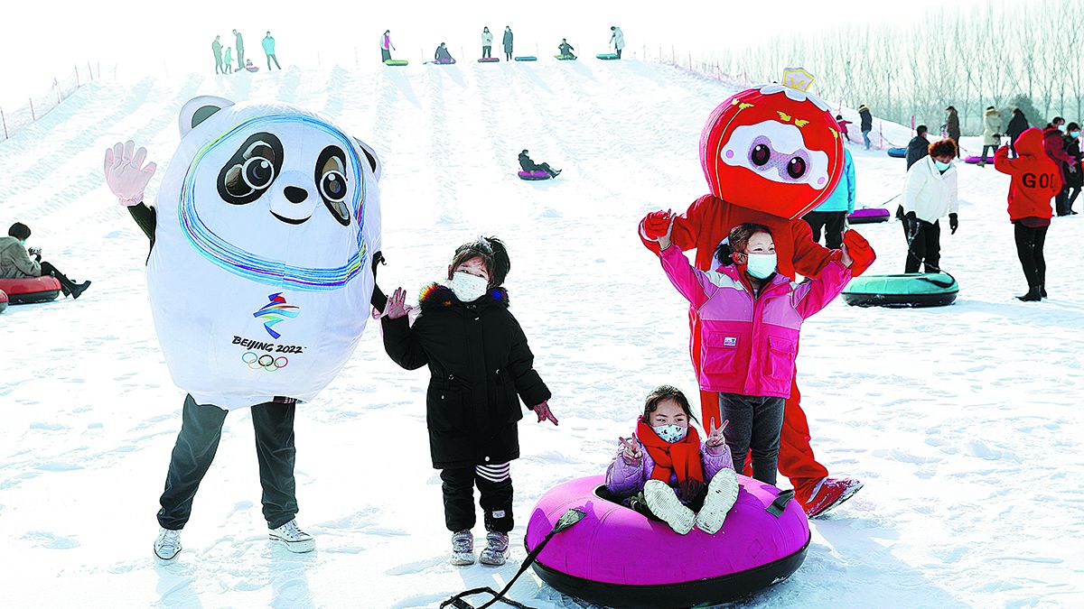 Personas disfrutan de deportes de invierno en una estación de esquí en el distrito de Yanqing