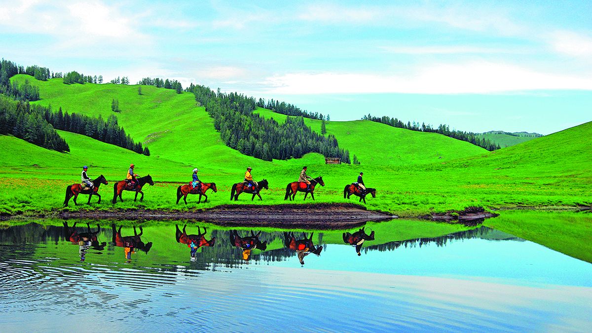 Turistas en un tour a caballo en la Región Autónoma Uygur de Xinjiang. PARA USO DE CHINA DAILY