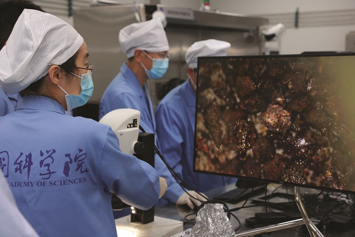 Una investigadora del Observatorio Astronómico Nacional de la Academia de Ciencias de China observa, en julio del año pasado, con microscopio fragmentos de rocas y suelo lunar recolectados por la sonda Chang’e-6 en la cara oculta de la Luna. PARA USO DE CHINA DAILY